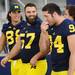 A bearded senior Elliott Mealer smiles as he walks out with his Michigan teammates during media day at the Al Glick Field House on Sunday afternoon. Melanie Maxwell I AnnArbor.com